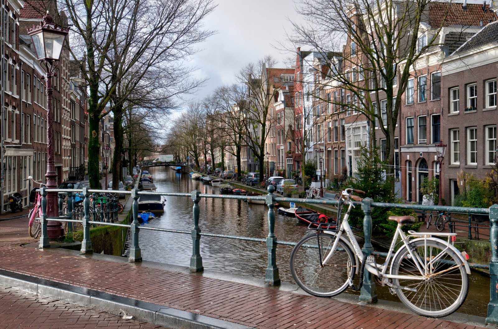 anal and bridge in the Jordaan neighborhood of Amsterdam with bicycles and historic houses along the water