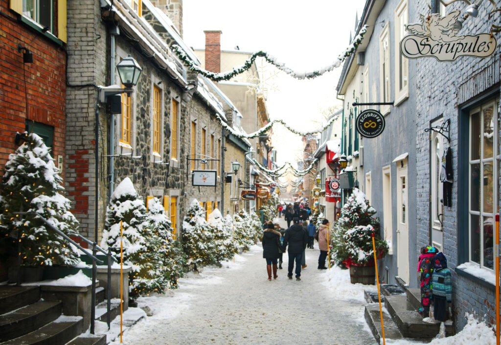 Snow-covered historic street decorated for the holidays in Old Québec City.